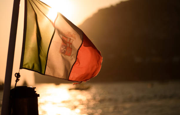 Sunset through Italian Naval flag on sailboat off the coast of Capri